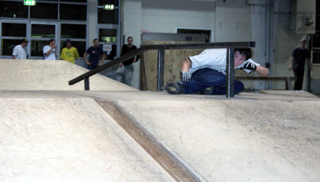 Cess slide under the rail by Christian Berg at Copenhagen Skatepark, Copenhagen